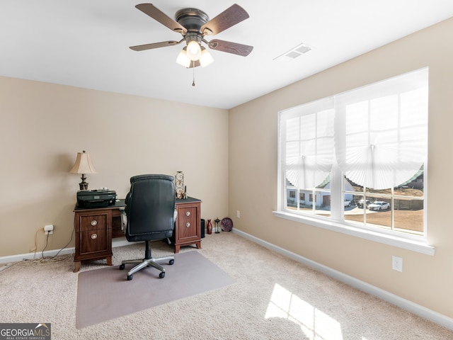 carpeted office with ceiling fan