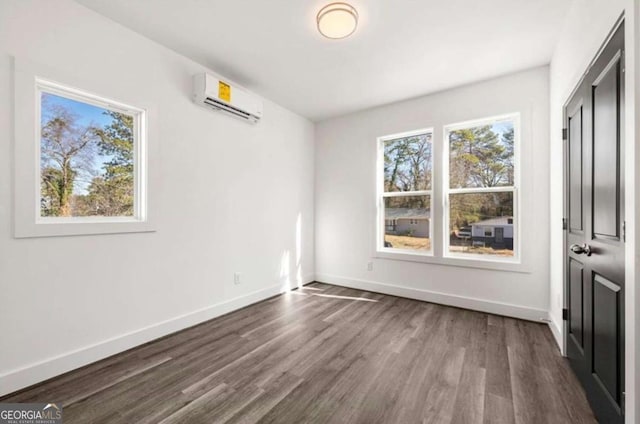 unfurnished bedroom with a wall mounted air conditioner and dark wood-type flooring