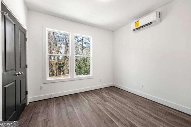 interior space with an AC wall unit and wood-type flooring