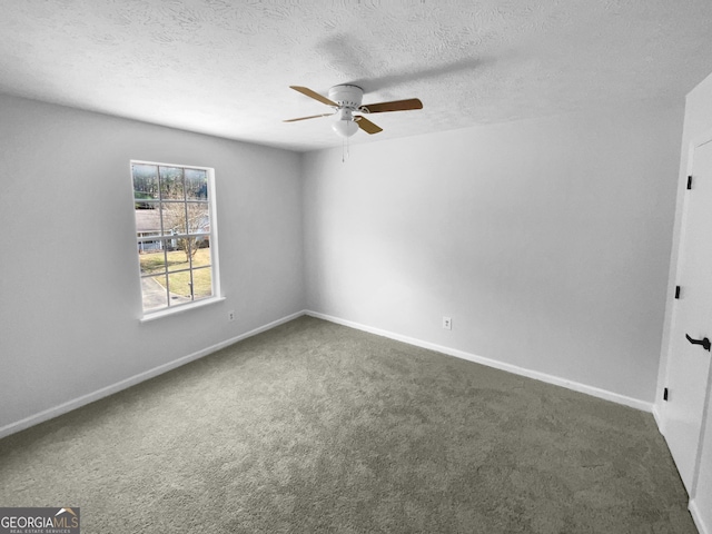 unfurnished room with ceiling fan, dark colored carpet, and a textured ceiling