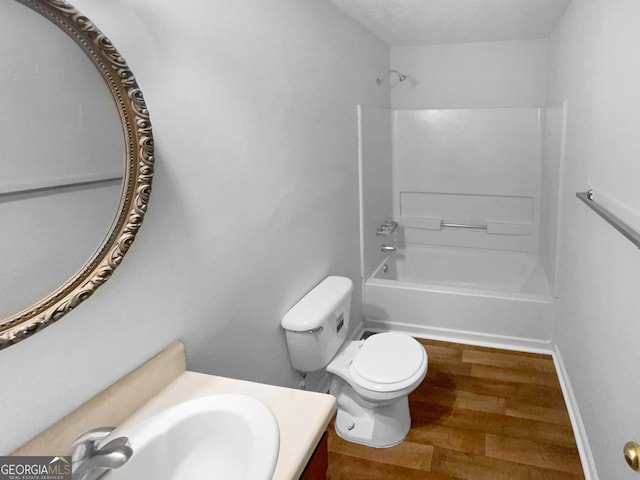 full bathroom featuring toilet, vanity, tub / shower combination, and wood-type flooring
