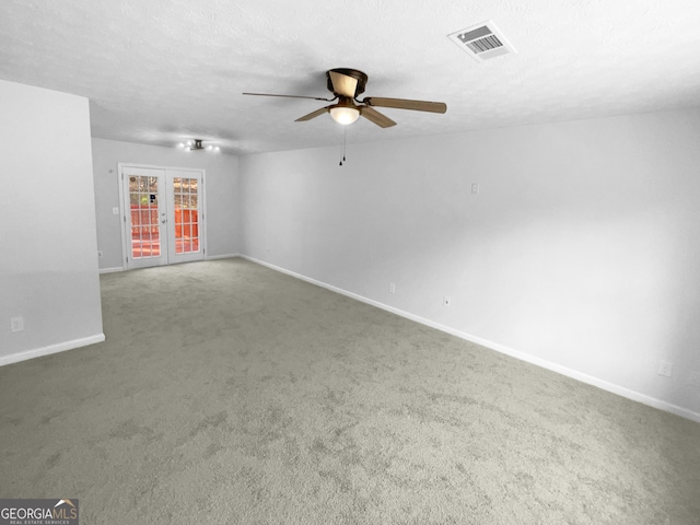 interior space with french doors, ceiling fan, carpet flooring, and a textured ceiling