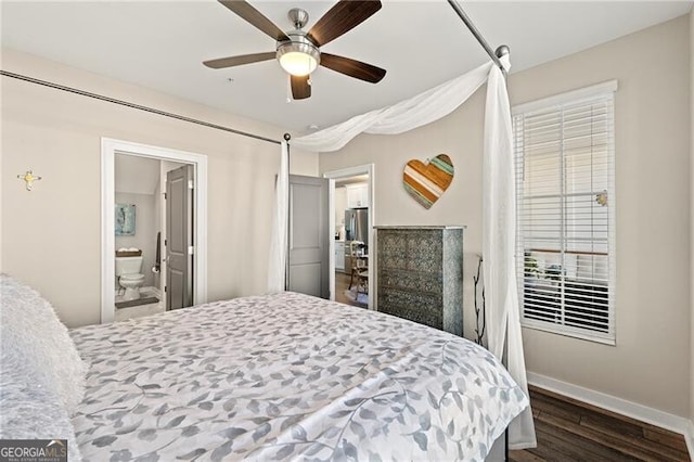 bedroom featuring ceiling fan, dark hardwood / wood-style floors, and connected bathroom