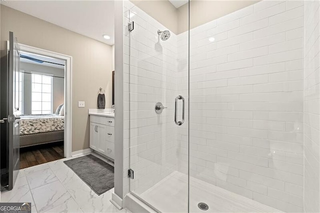 bathroom featuring vanity and a shower with door