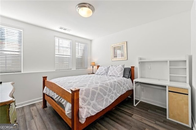 bedroom with dark wood-type flooring