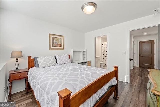 bedroom featuring dark hardwood / wood-style flooring and connected bathroom