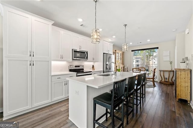 kitchen featuring sink, a kitchen island with sink, white cabinetry, and stainless steel appliances