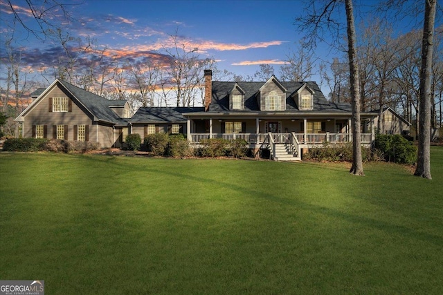 view of front of house with a porch and a lawn