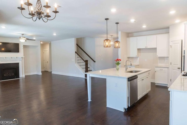 kitchen featuring recessed lighting, stainless steel appliances, a fireplace, a sink, and open floor plan