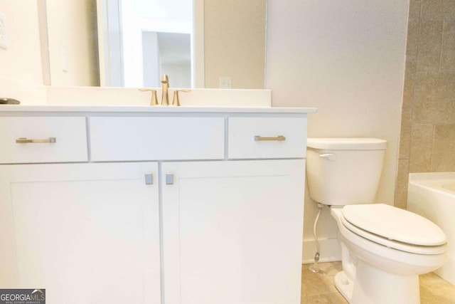 bathroom featuring vanity, toilet, and baseboards