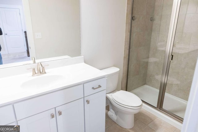 full bathroom with toilet, a stall shower, tile patterned floors, and vanity