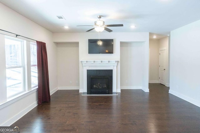unfurnished living room featuring ceiling fan, recessed lighting, dark wood finished floors, and baseboards