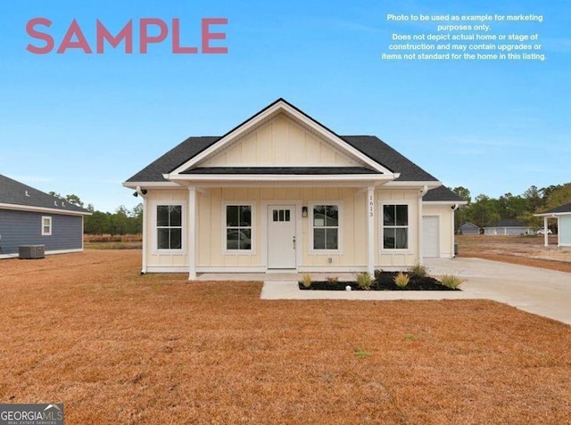 view of front facade featuring a garage, a front yard, central air condition unit, and a porch