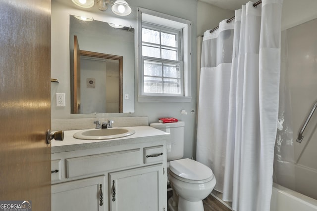 full bathroom featuring shower / bath combo with shower curtain, vanity, and toilet