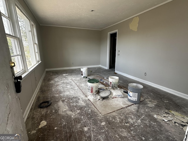 unfurnished room with a textured ceiling and crown molding