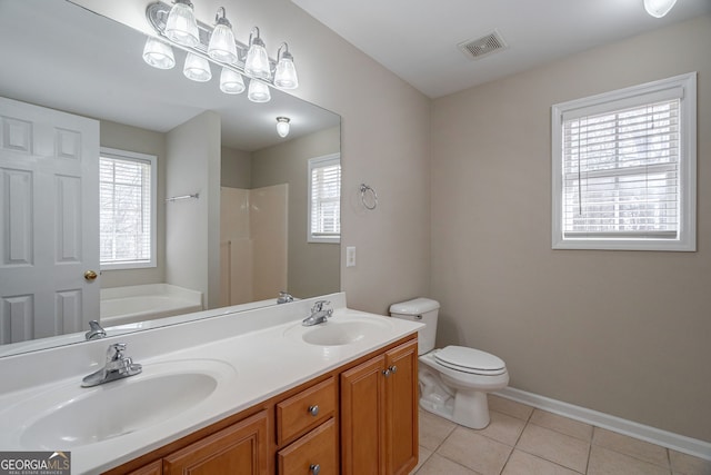 bathroom with a sink, tile patterned flooring, visible vents, and a bath