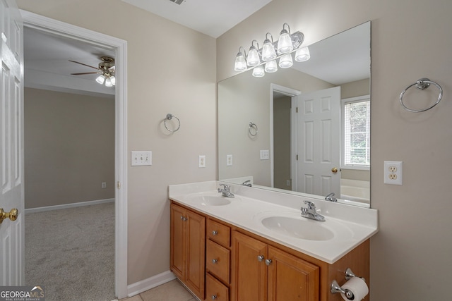 full bath with a ceiling fan, a sink, baseboards, and double vanity