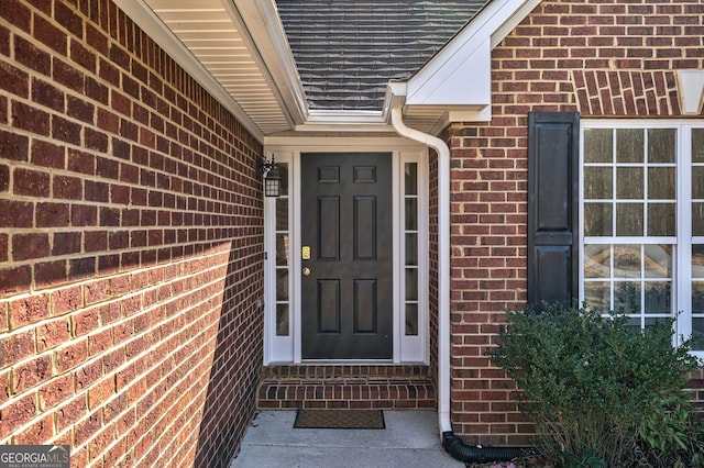 property entrance with brick siding