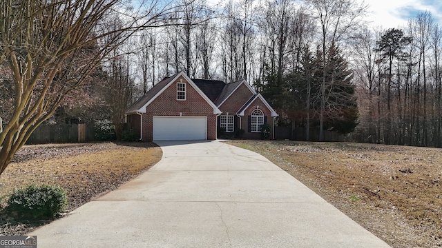 traditional-style home with brick siding, driveway, and fence