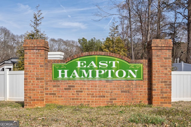 community sign featuring fence