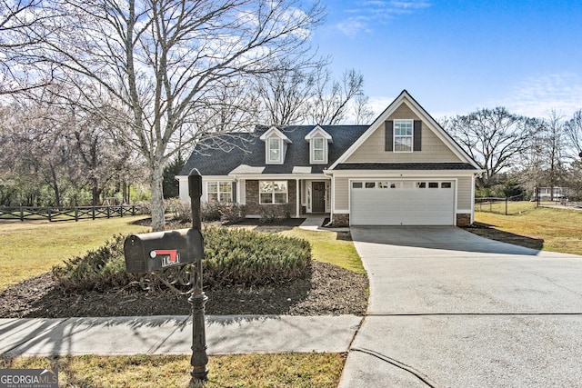 view of front of house with a garage, fence, driveway, and a front lawn