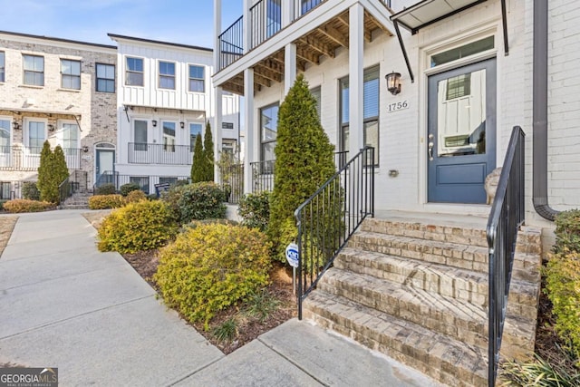 view of exterior entry featuring brick siding