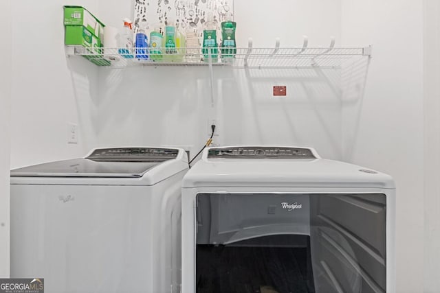 washroom with laundry area, separate washer and dryer, and wood finished floors