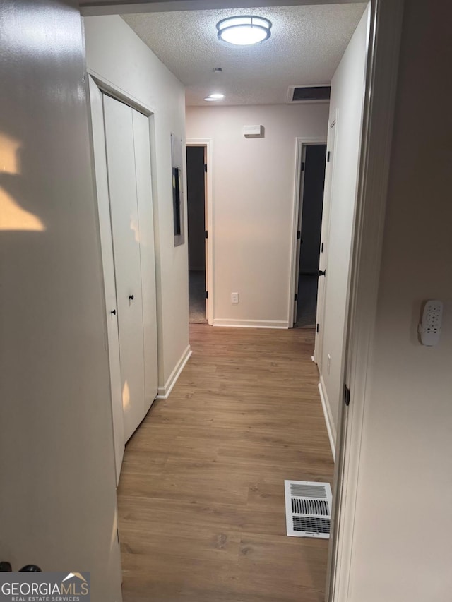 1753 Lee St, Decatur, GA 30035 - hall featuring light hardwood / wood-style flooring and a textured ceiling