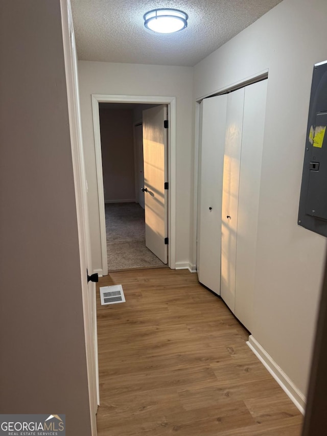 1753 Lee St, Decatur, GA 30035 - hallway with a textured ceiling, electric panel, and light hardwood / wood-style flooring