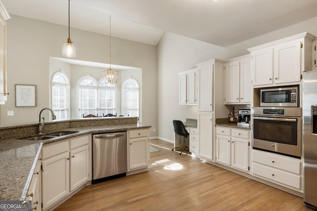 kitchen featuring white cabinets, stainless steel appliances, and a sink