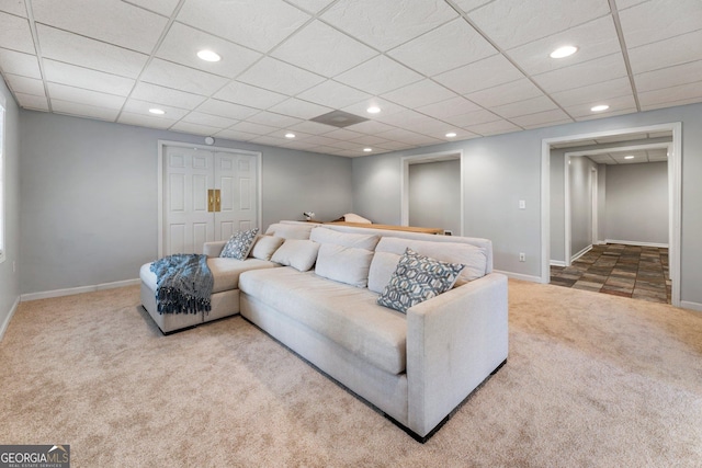 carpeted living area with baseboards, a drop ceiling, and recessed lighting