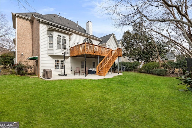 rear view of property with a yard, a chimney, a patio, stairway, and a deck