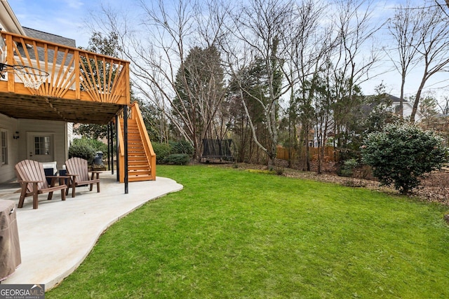 view of yard with a deck, a patio area, and stairway