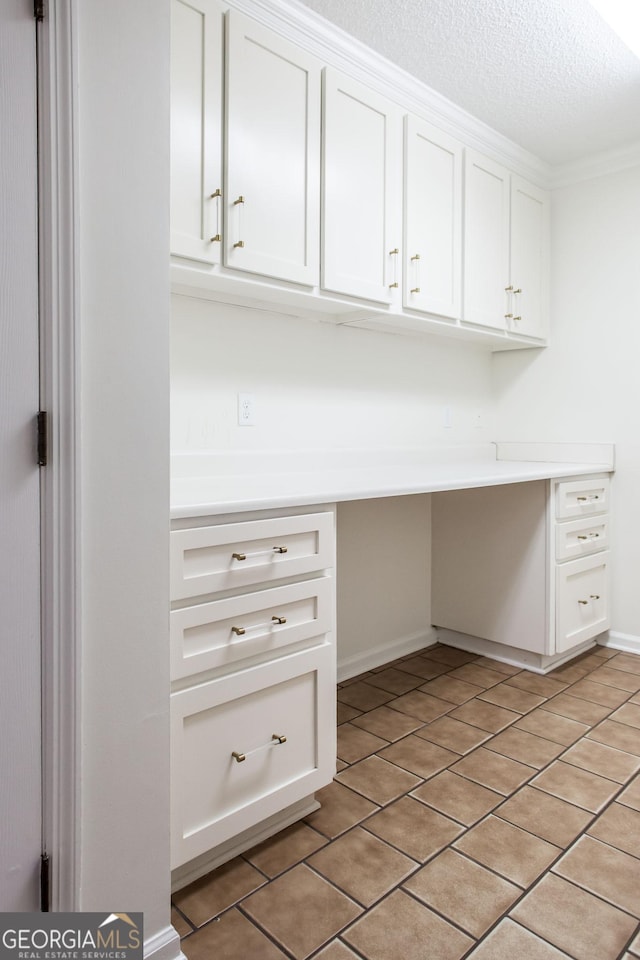 702 Hillmont Dr, Waycross, GA 31503 - unfurnished office with a textured ceiling, built in desk, and light tile patterned floors