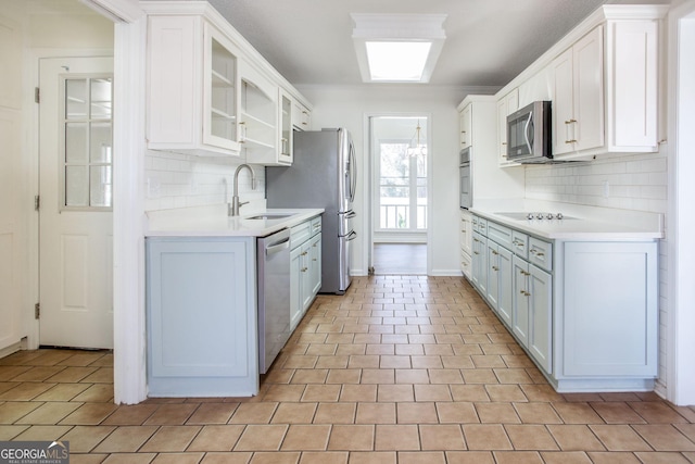 702 Hillmont Dr, Waycross, GA 31503 - kitchen featuring stainless steel appliances, light countertops, backsplash, and white cabinetry