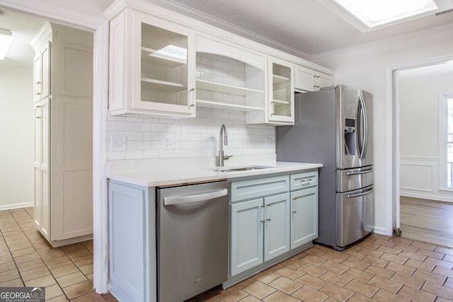 702 Hillmont Dr, Waycross, GA 31503 - kitchen featuring stainless steel appliances, light countertops, backsplash, ornamental molding, and white cabinetry