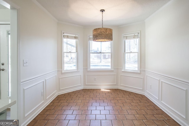 702 Hillmont Dr, Waycross, GA 31503 - unfurnished dining area with wainscoting, a decorative wall, and ornamental molding