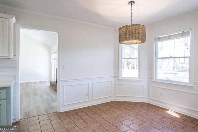 702 Hillmont Dr, Waycross, GA 31503 - unfurnished dining area featuring ornamental molding and wainscoting