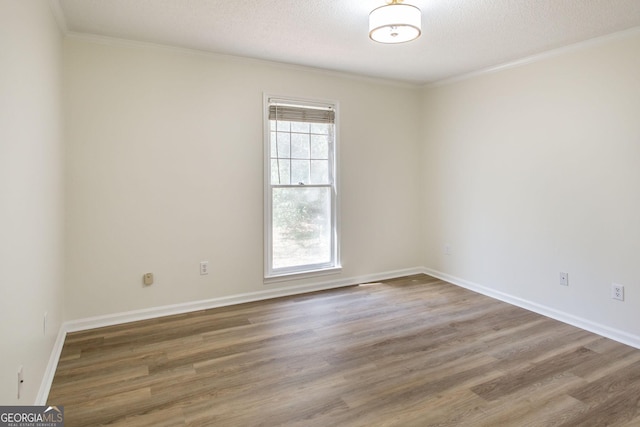 702 Hillmont Dr, Waycross, GA 31503 - empty room featuring wood finished floors, crown molding, and a textured ceiling