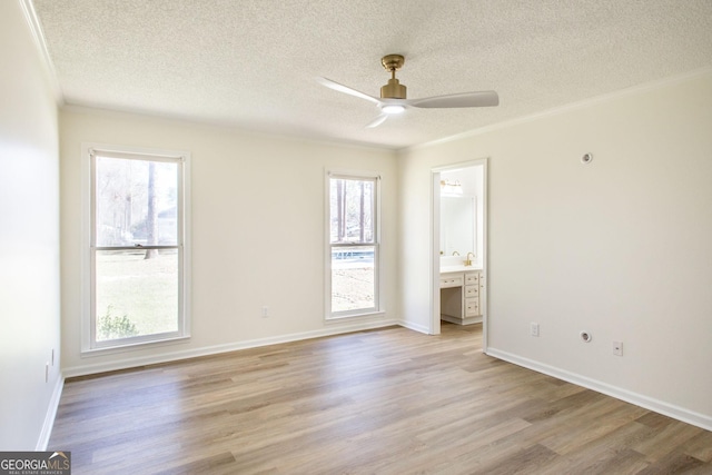 702 Hillmont Dr, Waycross, GA 31503 - empty room featuring a textured ceiling, light wood-style flooring, healthy amount of natural light, ceiling fan, and crown molding