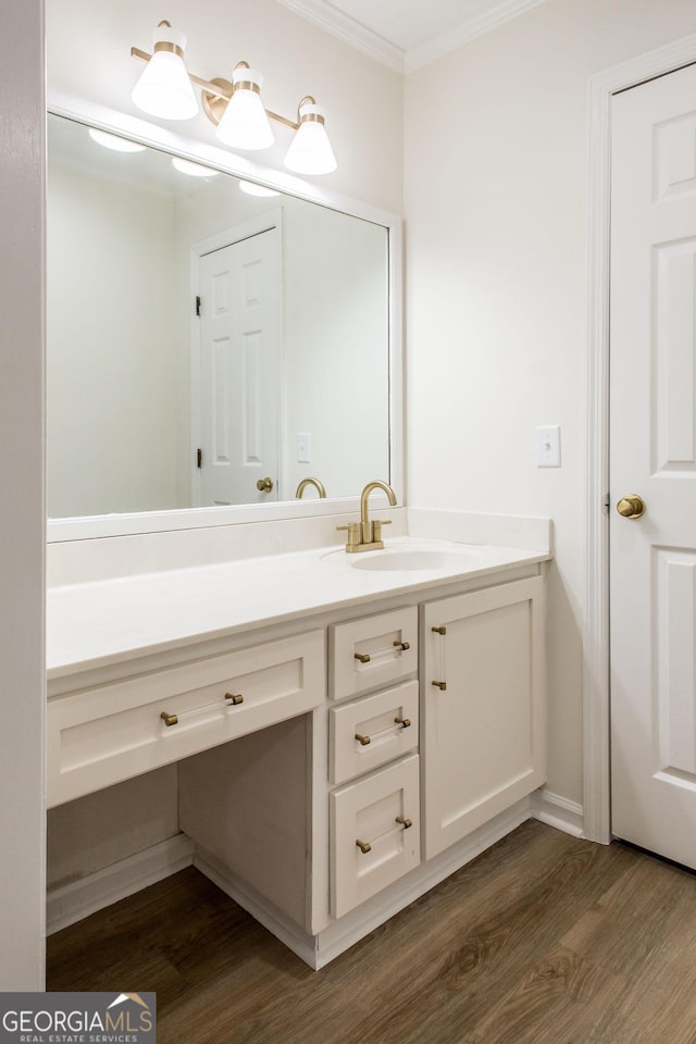 702 Hillmont Dr, Waycross, GA 31503 - bathroom with wood finished floors, vanity, and ornamental molding