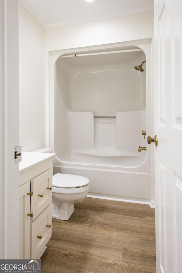 702 Hillmont Dr, Waycross, GA 31503 - full bath with vanity, wood finished floors, bathing tub / shower combination, and crown molding