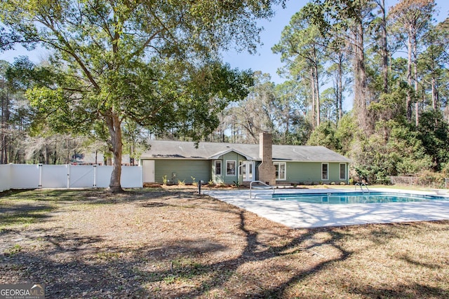702 Hillmont Dr, Waycross, GA 31503 - rear view of house featuring a gate, a chimney, and a patio