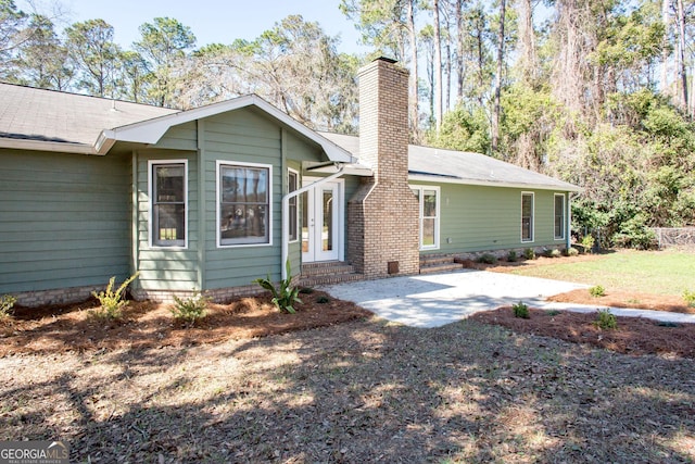 702 Hillmont Dr, Waycross, GA 31503 - rear view of property with a chimney, entry steps, and a patio area