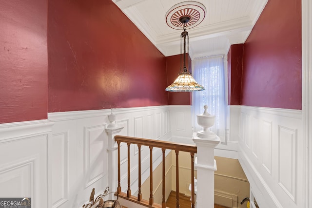 staircase featuring crown molding