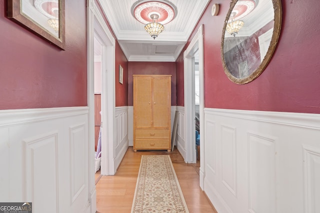 interior space with light wood-type flooring and crown molding