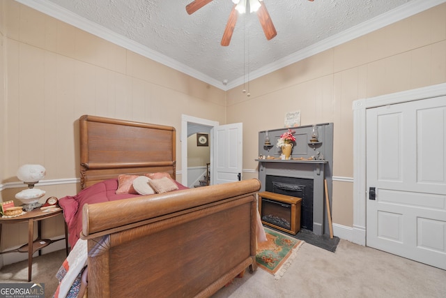 carpeted bedroom featuring a textured ceiling, ceiling fan, and ornamental molding