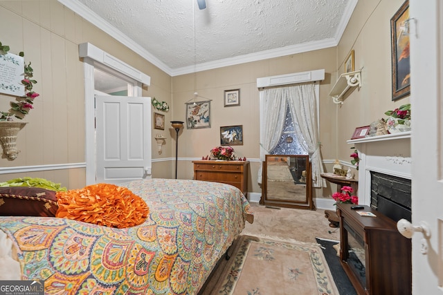 bedroom featuring a textured ceiling, ceiling fan, carpet flooring, and ornamental molding