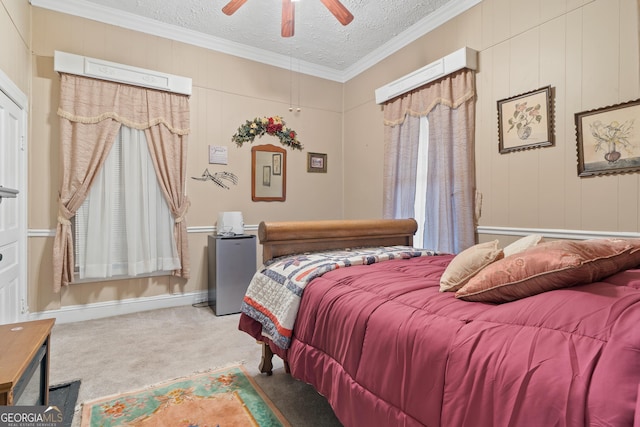 carpeted bedroom with a textured ceiling, crown molding, and ceiling fan