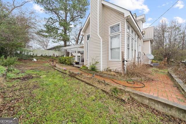 view of side of home featuring a patio and a pergola